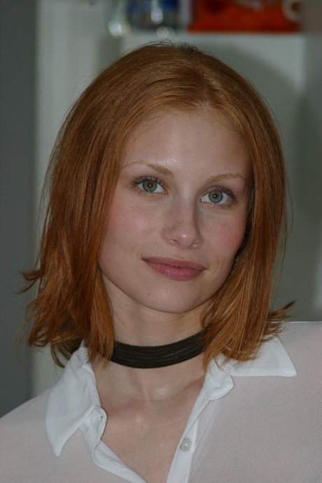 Pale redhead Anya poses naked on kitchen counter in a black choker 77970895
