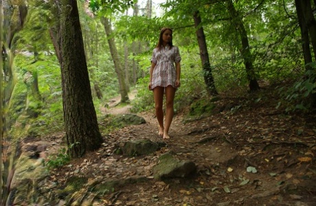Beautiful young girl Gloria gets totally naked during solo action in a forest 67770854