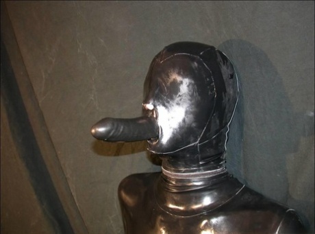 Solo model that is totally encased in latex has a dildo fitted into her mouth 51854340