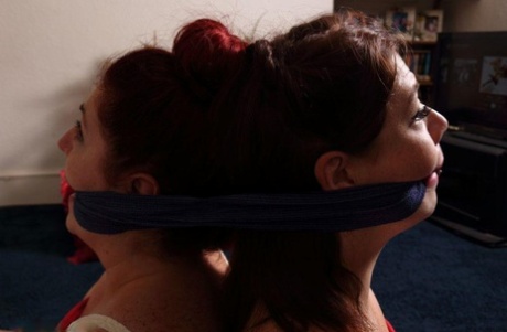 Two white girls find themselves tied up and cleave gagged together 64628133