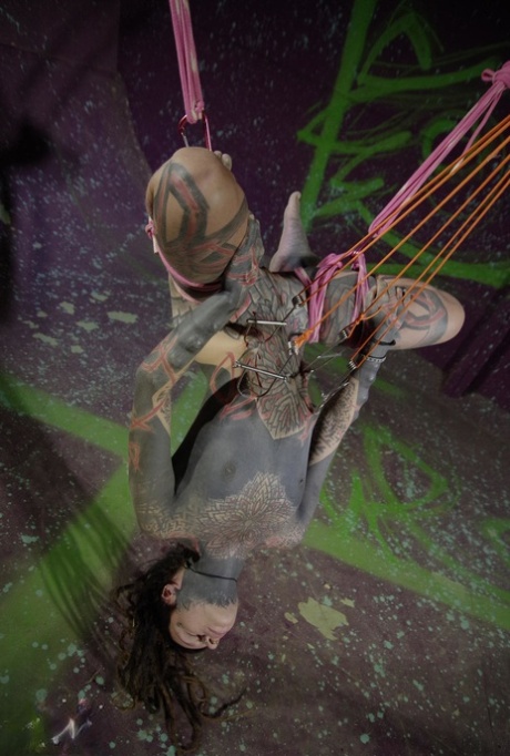 Completely tattooed female is suspended by ropes while totally naked 11019848