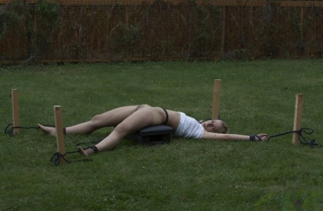 Young blonde girl is tortured in the backyard by her captor 16601823