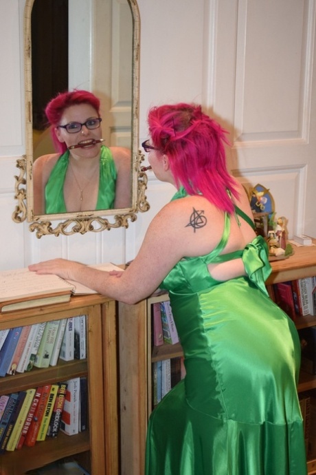 Tattooed amateur Mollie Foxxx exposes herself afore a fireplace in a dress 48192958