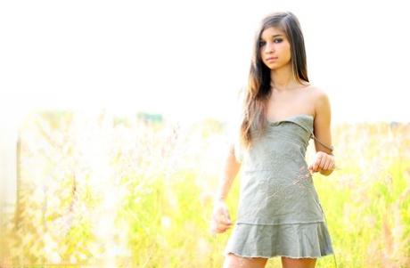 Alluring brunette teen Nika shows her tight slit while naked on green grass 75910008